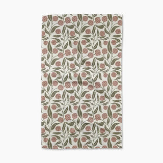 Floral patterned towel with pink flowers and green leaves on a white background