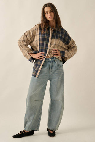 Person wearing a plaid shirt and jeans on a plain background