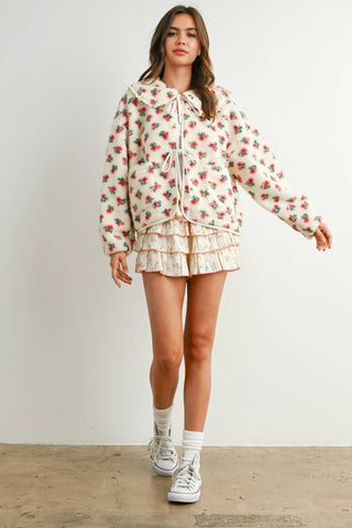 Woman wearing a floral outfit with a white background