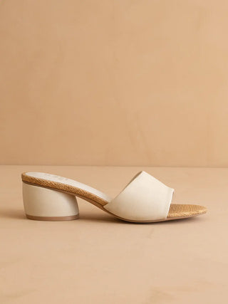 White sandal with wooden sole on a beige background