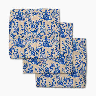 Set of folded towels with blue bottle pattern on a beige background