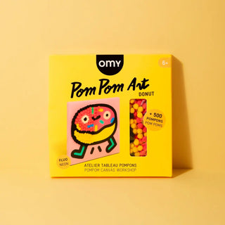 Yellow packaging of OMY Pom Pom Art Donut on a yellow background