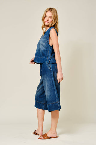Woman wearing a denim outfit on a plain background