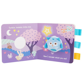 Children's soft book with owl illustration on a purple background
