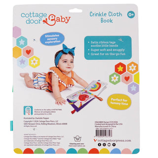 Cottage Door Baby crinkle cloth book packaging with a child and colorful design elements.