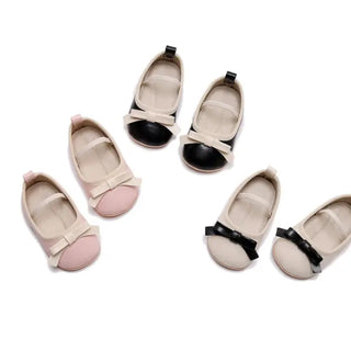 Set of children's shoes with bow details on a white background