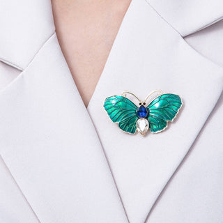 Green butterfly brooch on a white shirt