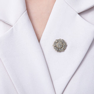 Silver brooch on a white blazer