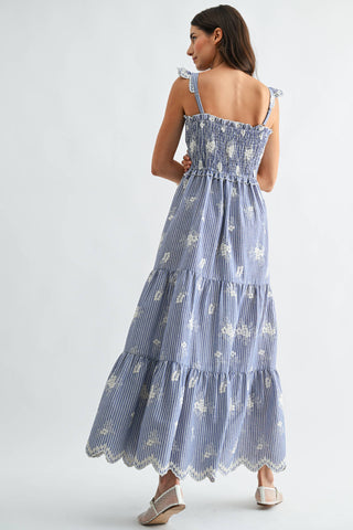Woman wearing a blue floral dress on a white background