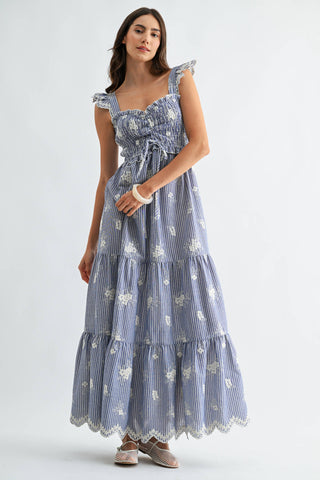 Woman wearing a blue floral dress on a white background