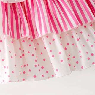 Skirt with pink and white striped top and polka dot bottom on a white background
