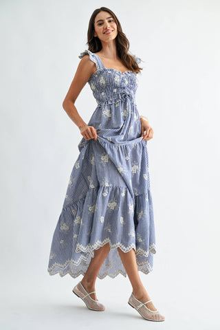 Woman wearing a blue floral dress on a white background