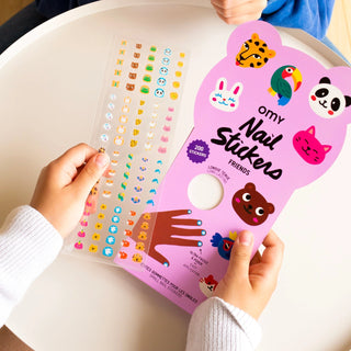 Pink packaging of nail stickers with colorful designs on a white surface