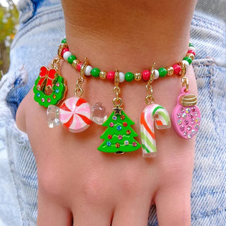 Colorful Christmas-themed anklet on a person's ankle with denim background