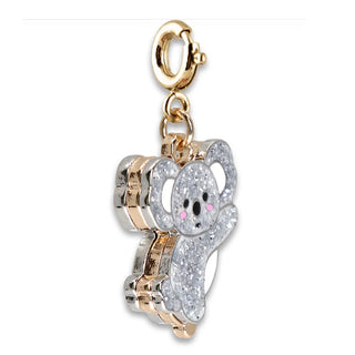 A gold and silver-tone charm shaped like a koala, encrusted with clear pavé stones and accented with tiny pink details, attached to a gold lobster clasp on a white background.