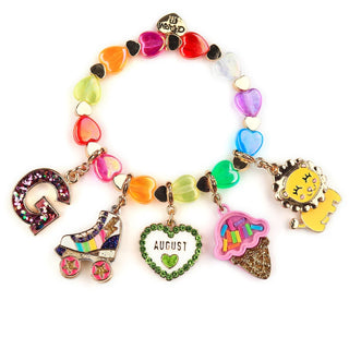 A colorful charm bracelet with heart-shaped links and multiple dangling charms, including a glittery letter G, a roller skate, an August heart, a pink ice cream cone, and a yellow cartoon character charm, shown on a white background.
