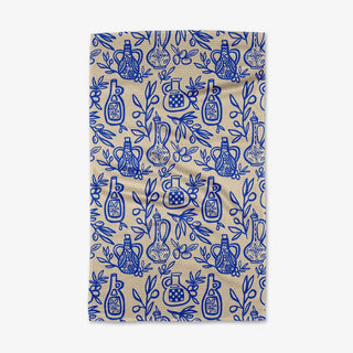 Beige towel with blue pattern of bottles and leaves on a white background