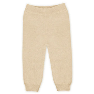 Beige knitted baby pants on a white background