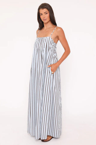 Woman wearing a black and white striped dress on a white background