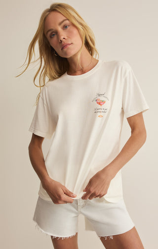Woman wearing a white t-shirt with a graphic design on a plain background