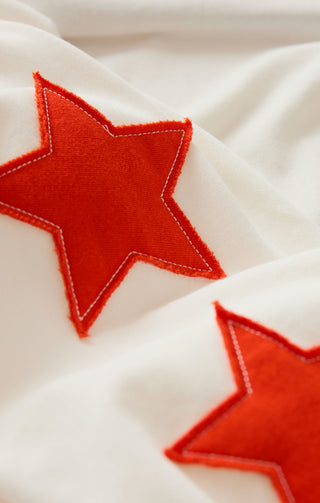 Close-up of red stars on a white fabric background