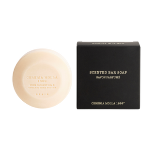 Bar of soap and its packaging on a white background