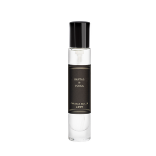 Perfume bottle with black cap and label on a white background