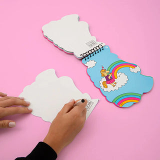 Colorful notebook with a unicorn and rainbow design on a pink background