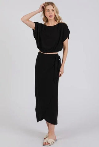 Woman wearing a black outfit on a white background
